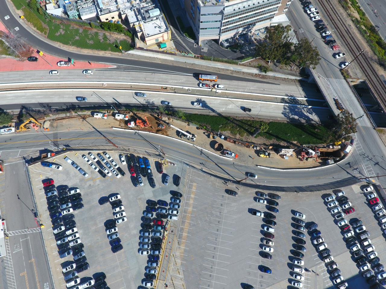 photo overhead view of freeway and parking lot and construction site