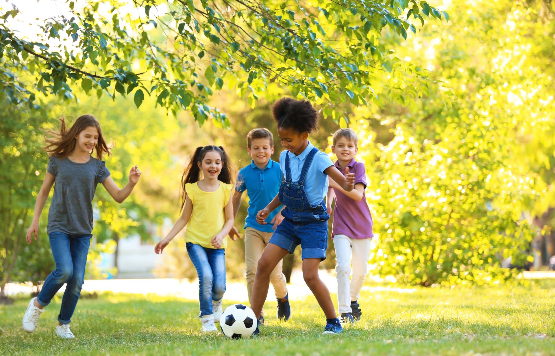 Children Playing Soccer at Park_AdobeStock_210522812